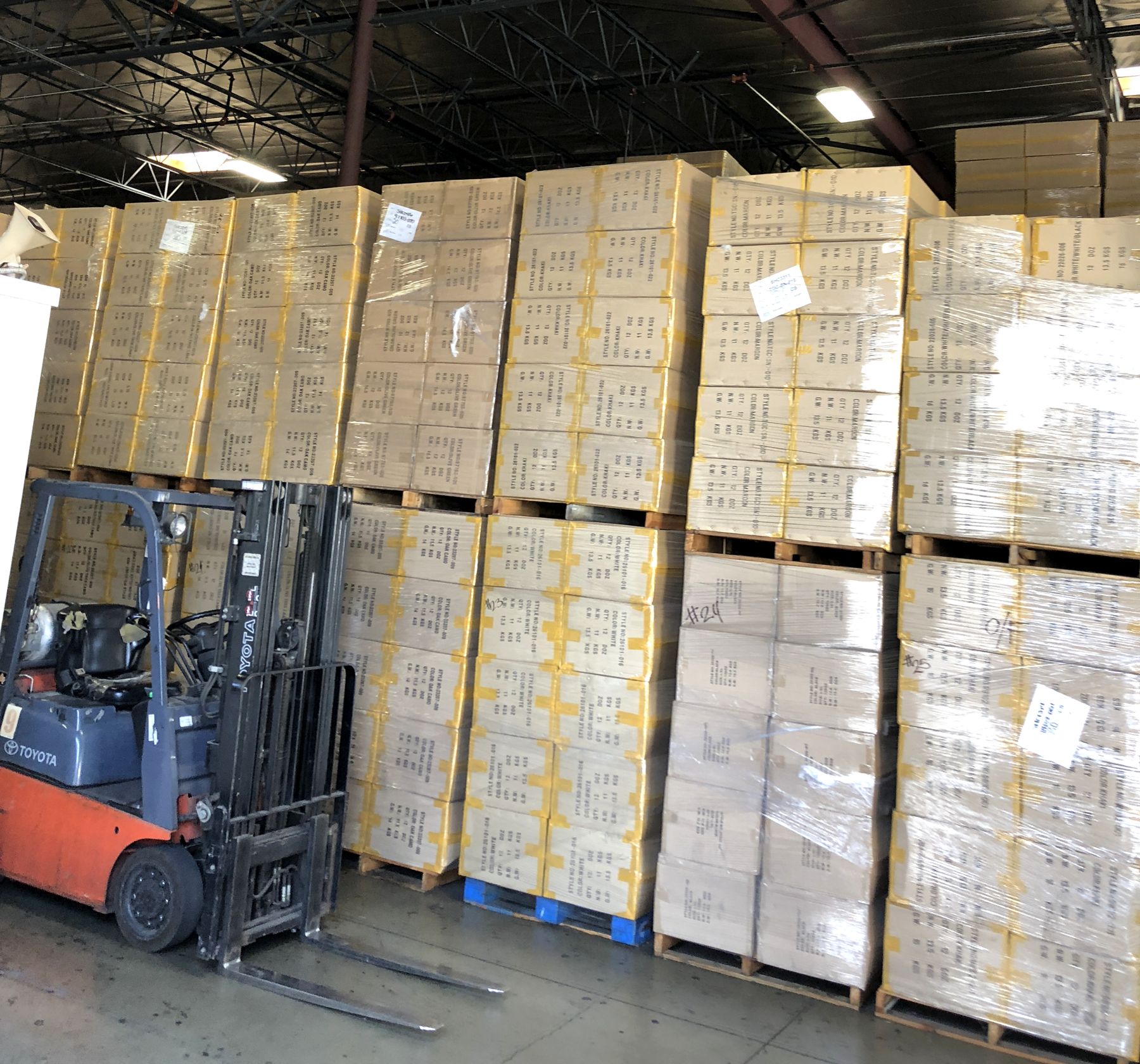 DSG warehouse inventory of promotional bags and hats on pallets in Chino, CA